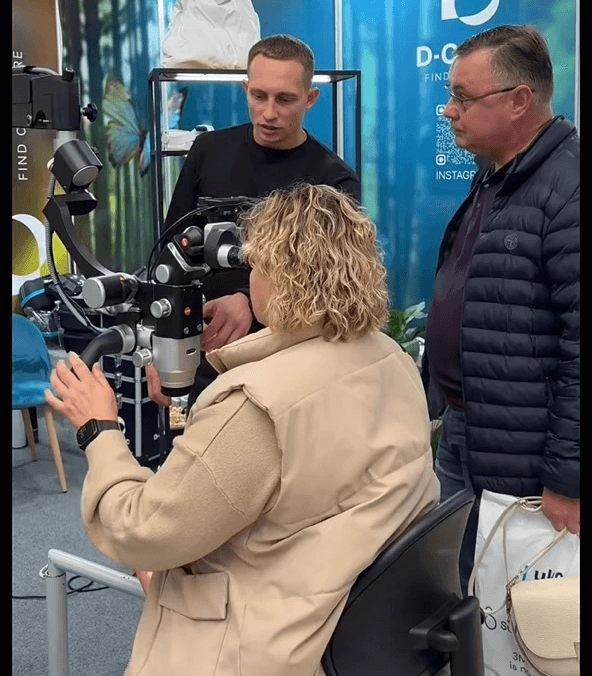 Two people observe the "Karl Kaps" "Microscopes made in Germany