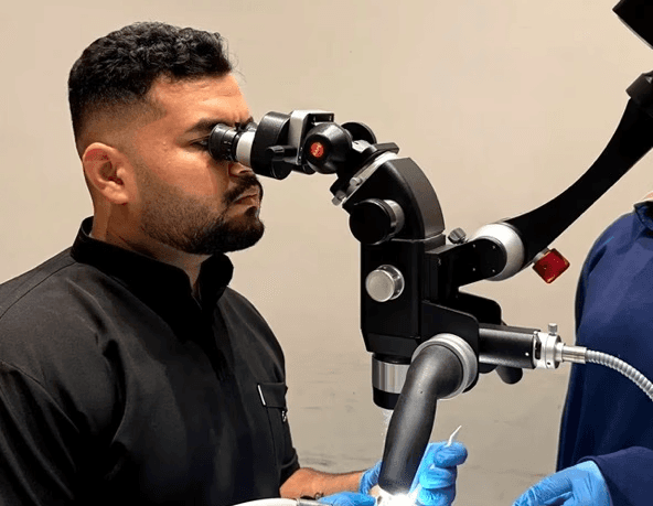 A professional uses Karl Kaps Microscopes made in Germany.